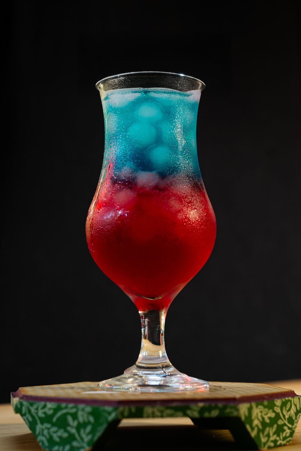 Red and blue cocktail on a dark background